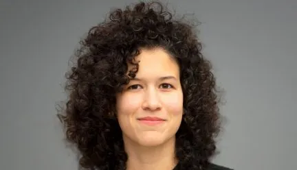 headshot of danniely staback against grey background 