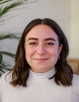 Headshot of Abby Peterson in front of a fern 