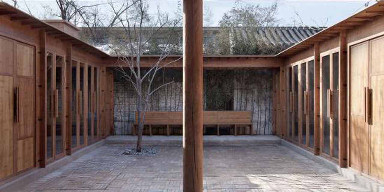 view into courtyard with column in foreground 