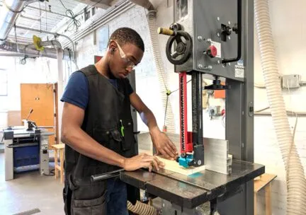 person using woodshop equipment