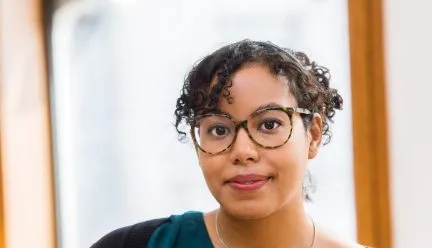 headshot of adrienne brown against brown background 