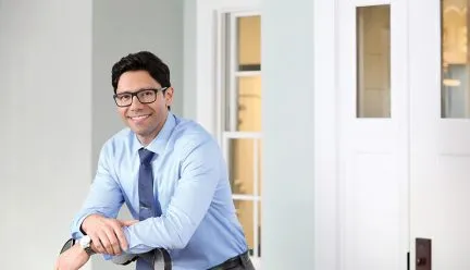 headshot of alex patsavas standing in an office 