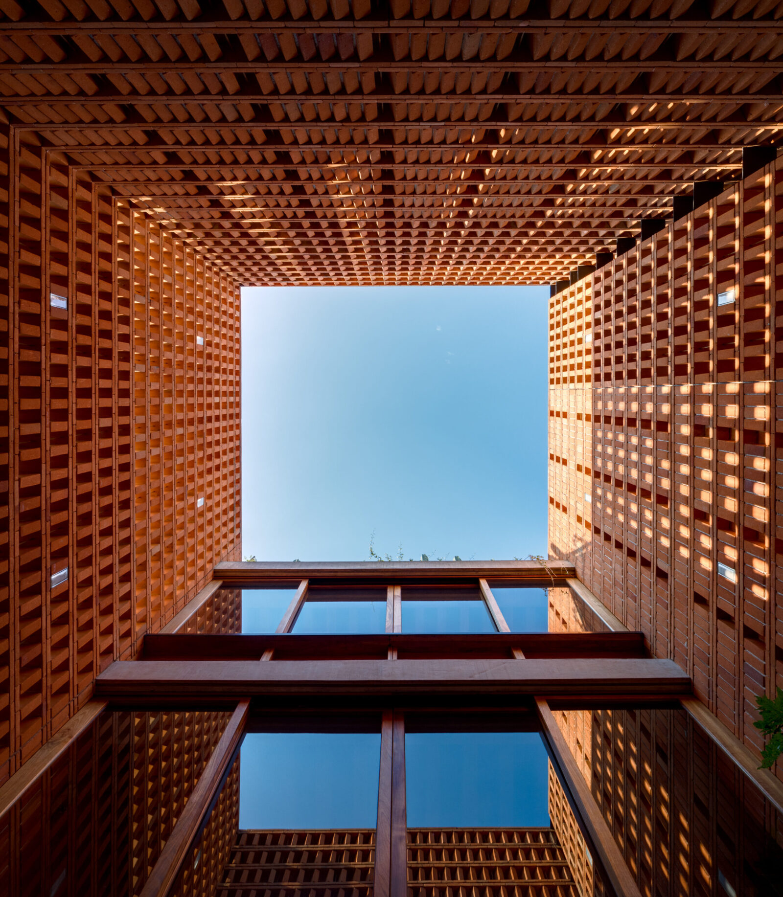 perspective photo looking up from a building courtyard 