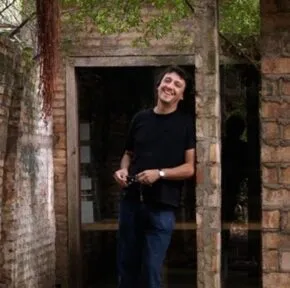 solano benitez in front of a masonry building 