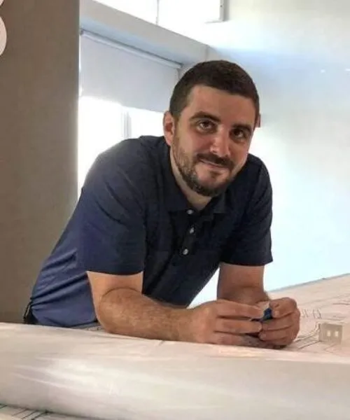 headshot of robin planas at a work desk 