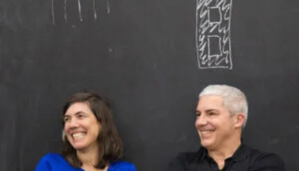 image of two designers in front of a blackboard 