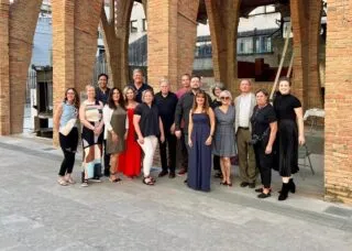 group standing in front of spanish architecture 