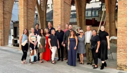 group standing in front of spanish architecture 