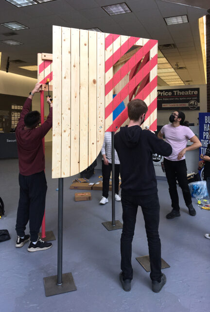 students assembling a wood installation