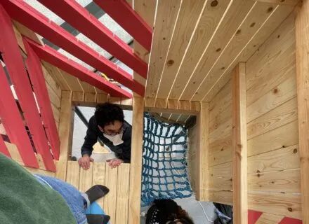 Chicago seminar, cardboard wood rectangle built 10 feet into the air with red painted coardboard at angles