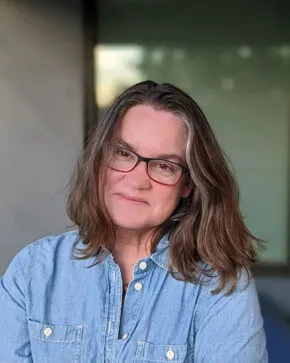 kathryn holliday wearing blue jean shirt and glasses