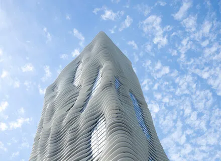 tall skyscraper building with lots of curves and white structure