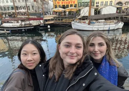 Students standing in front of water in Barcelona