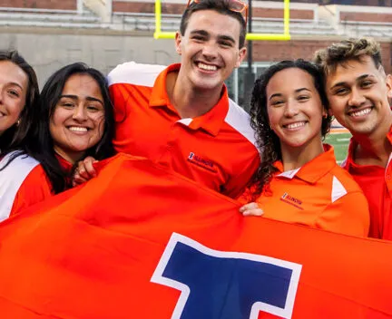 students smiling holding flag