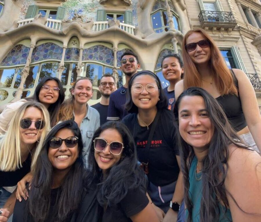 students in the study abroad program smiling in front of a beautiful architectural site