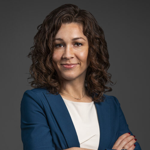 michelle ryland, brunette, blue blazer, olive complexion, smirking at camera with arms crossed, white top