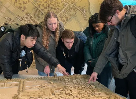 students standing around looking at a model