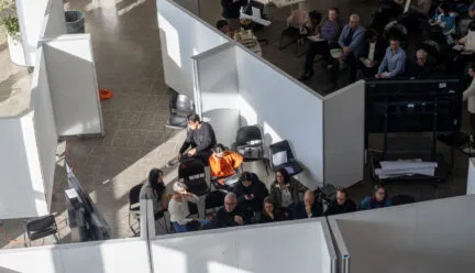 picture of the atrium with students during their fall 2024 midterm studio reviews