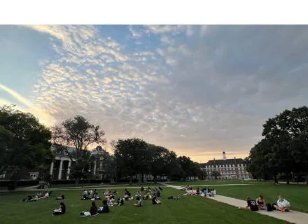 sun going down on students working in north quad