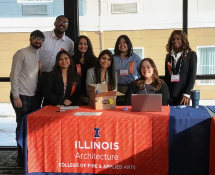 pictures of people smiling behind a desk