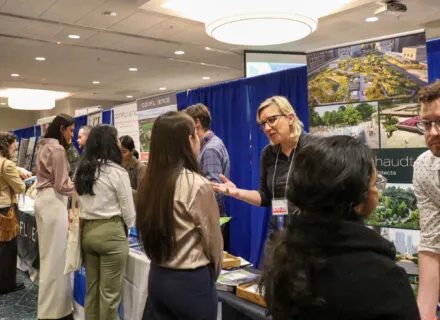 students standing and talking to representatives