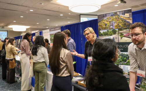 students standing and talking to representatives