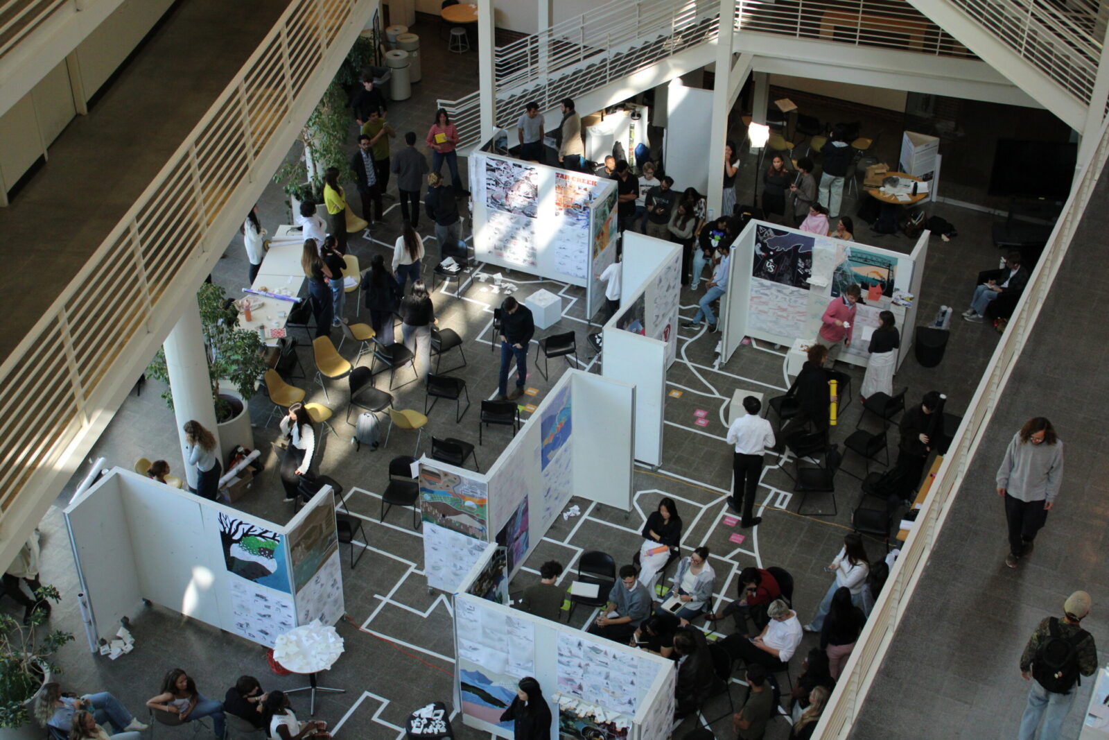overhead view of atrium with many people and z panels