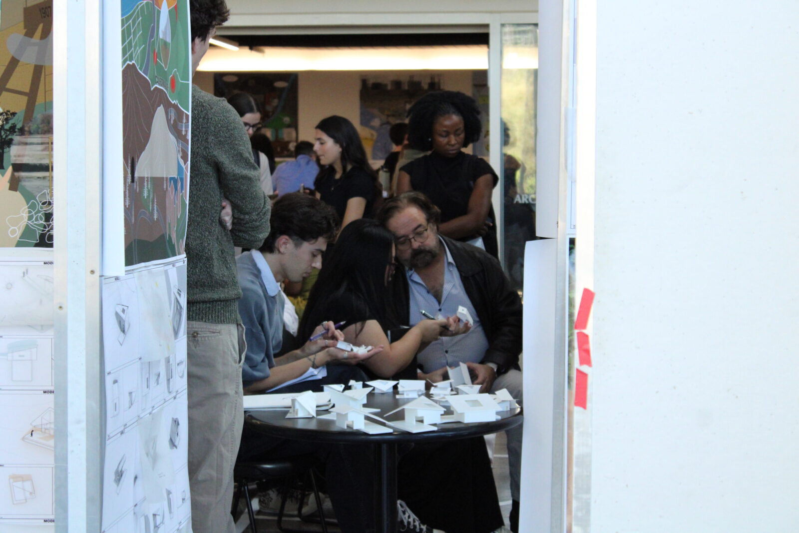 students looking at small models with reviewers