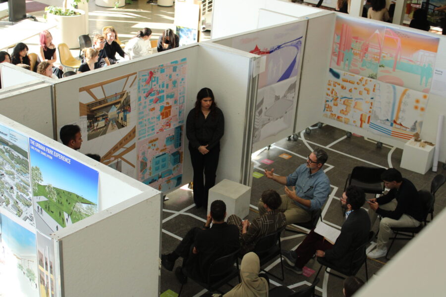students presenting posters to an audience