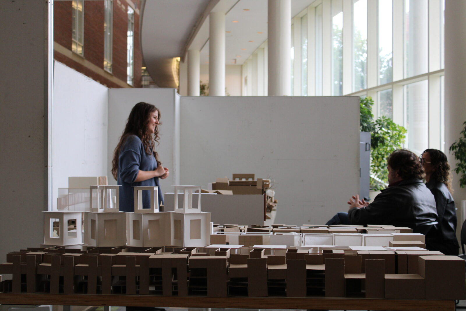 architectural models in front of a student presenting