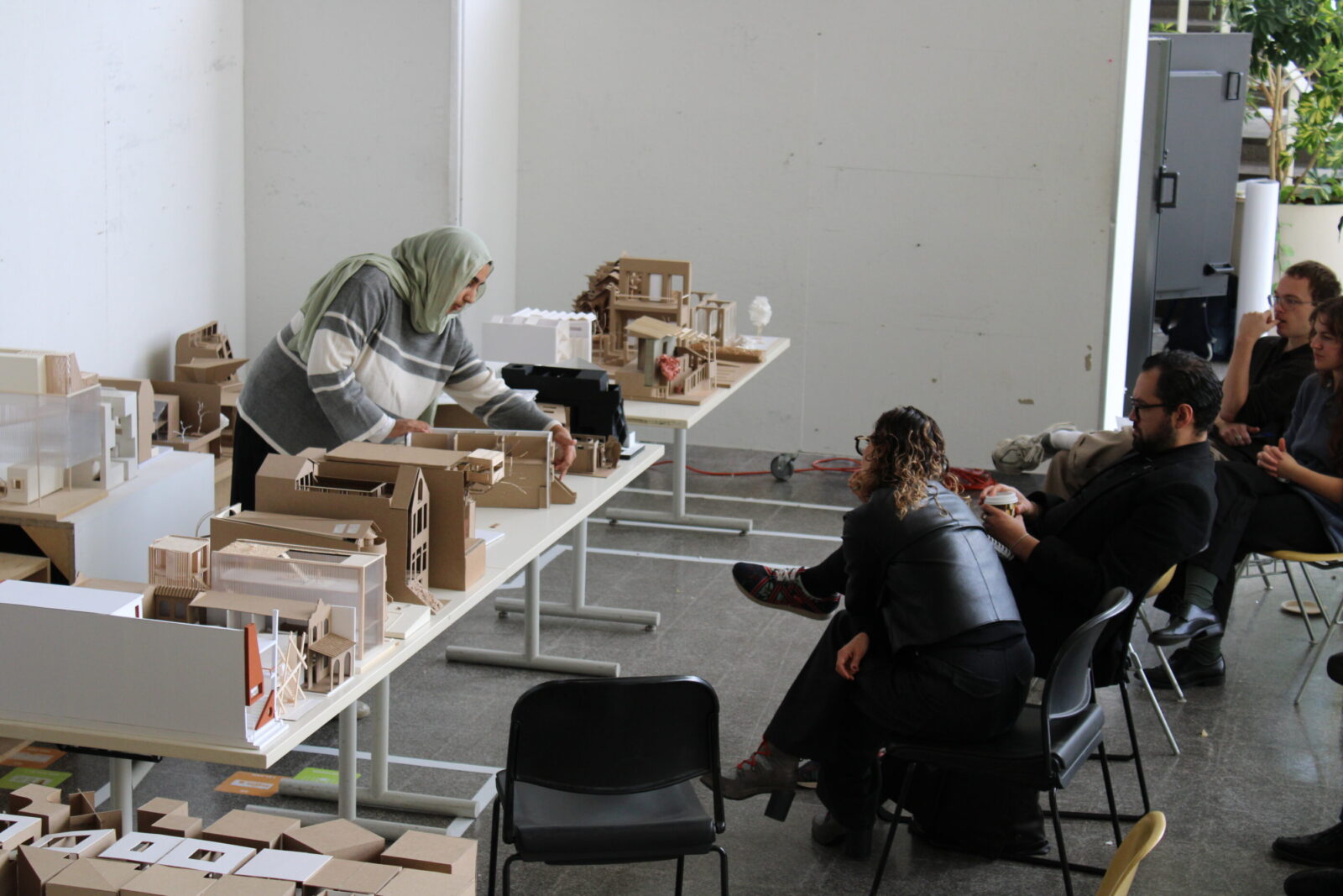a student presenting models in front of an audience