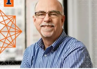 white man no hair blue and white striped shirt smiling at camera