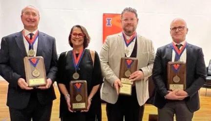 4 professors looking at the cemera and smiling