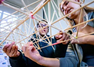 two people hold a truss