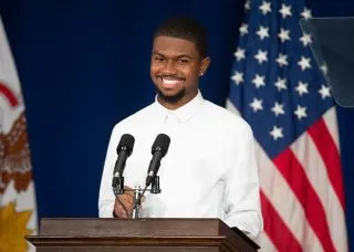 Amaury Saulsberry at a podium