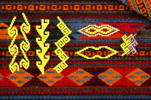 Yellow 3D printed motifs laid atop a traditional textile from which their designs were derived