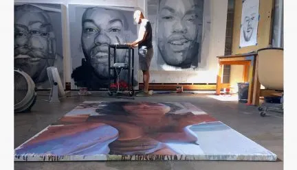 Patrick Earl Hammie in the studio with paintings