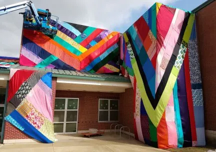 Colorful fabric installation around elementary school entrance