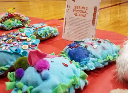 Photo of colorful pillow-shaped student artworks