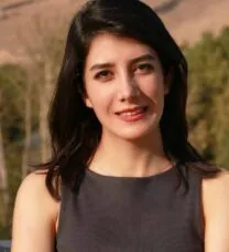 1/3 length portrait of the smiling student with arms folded