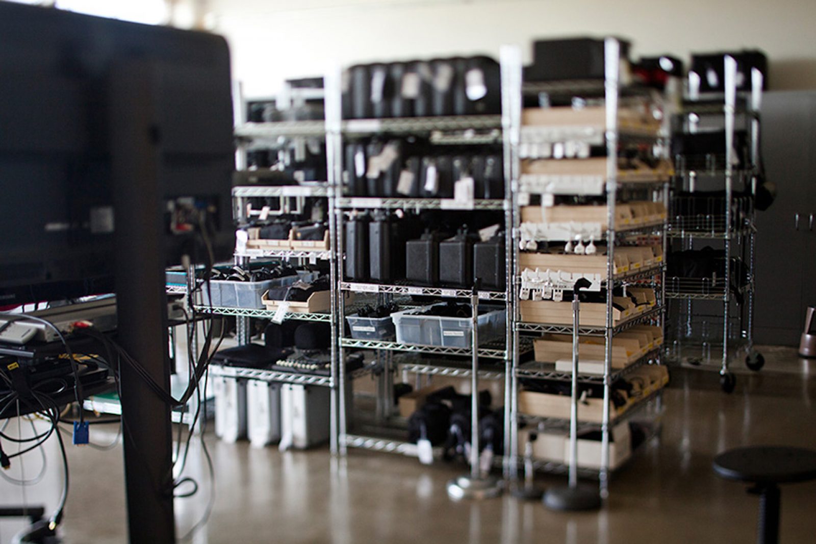 camera equipment on metal shelves