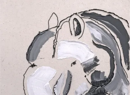 Photo of a student painting at an easel.