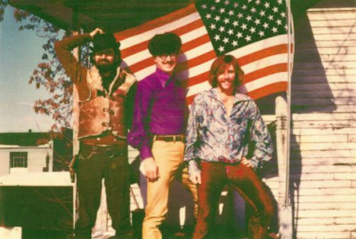 Vintage photo of three men and an American flag