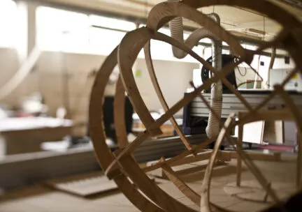 wooden framed orb on cnc router in woodshop