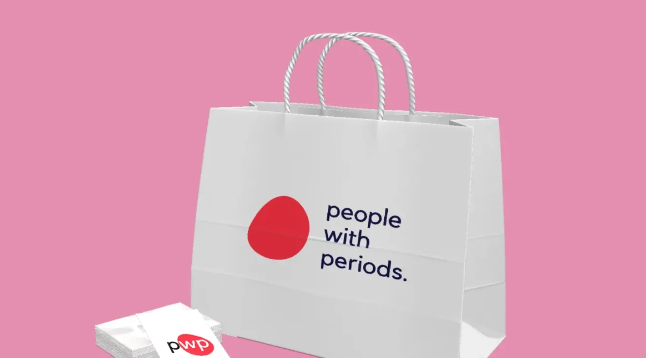 Digital image of a paper shopping bag and brochure with a red spot and the words "people with periods" with a period at the end of the text.