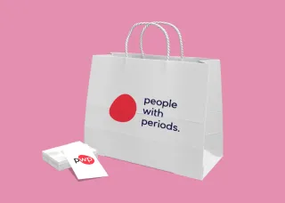 Digital image of a paper shopping bag and brochure with a red spot and the words "people with periods" with a period at the end of the text.