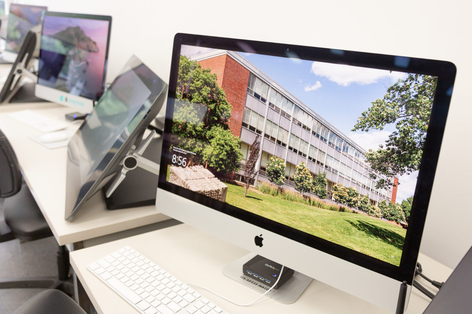 row of imacs with cintiq drawing tablets