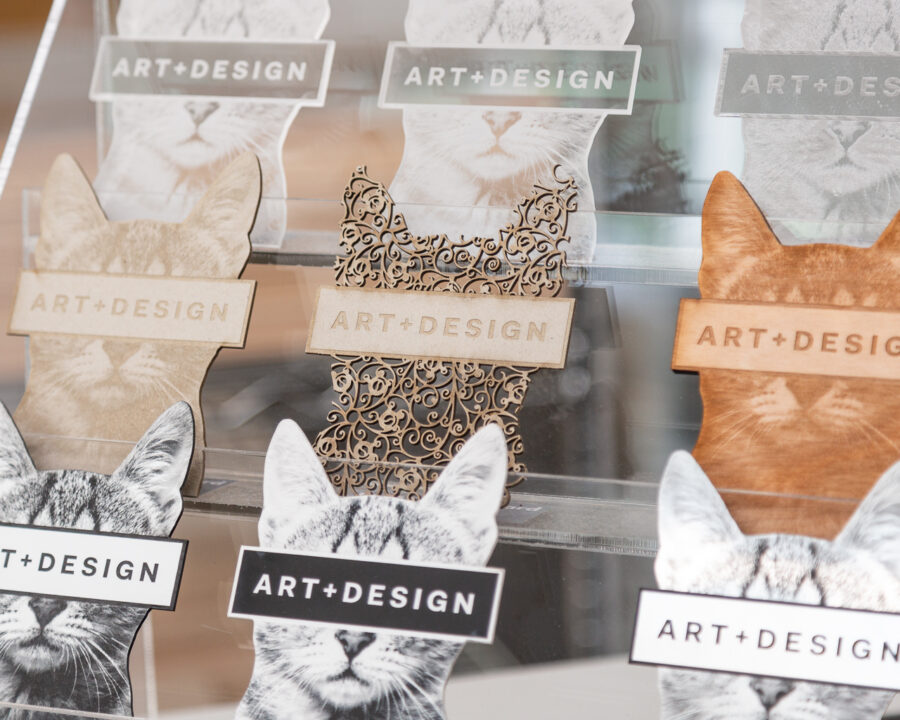 laser cut cat heads that say "art and design"