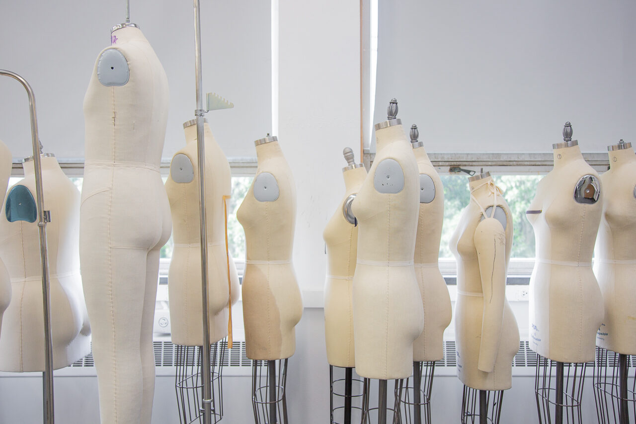 photo of yellow dress forms in front of windows