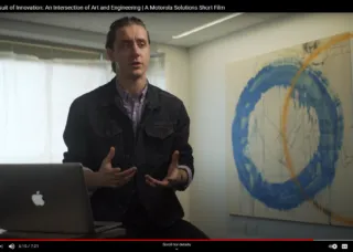 Sebastien Johnson talking with painting to side